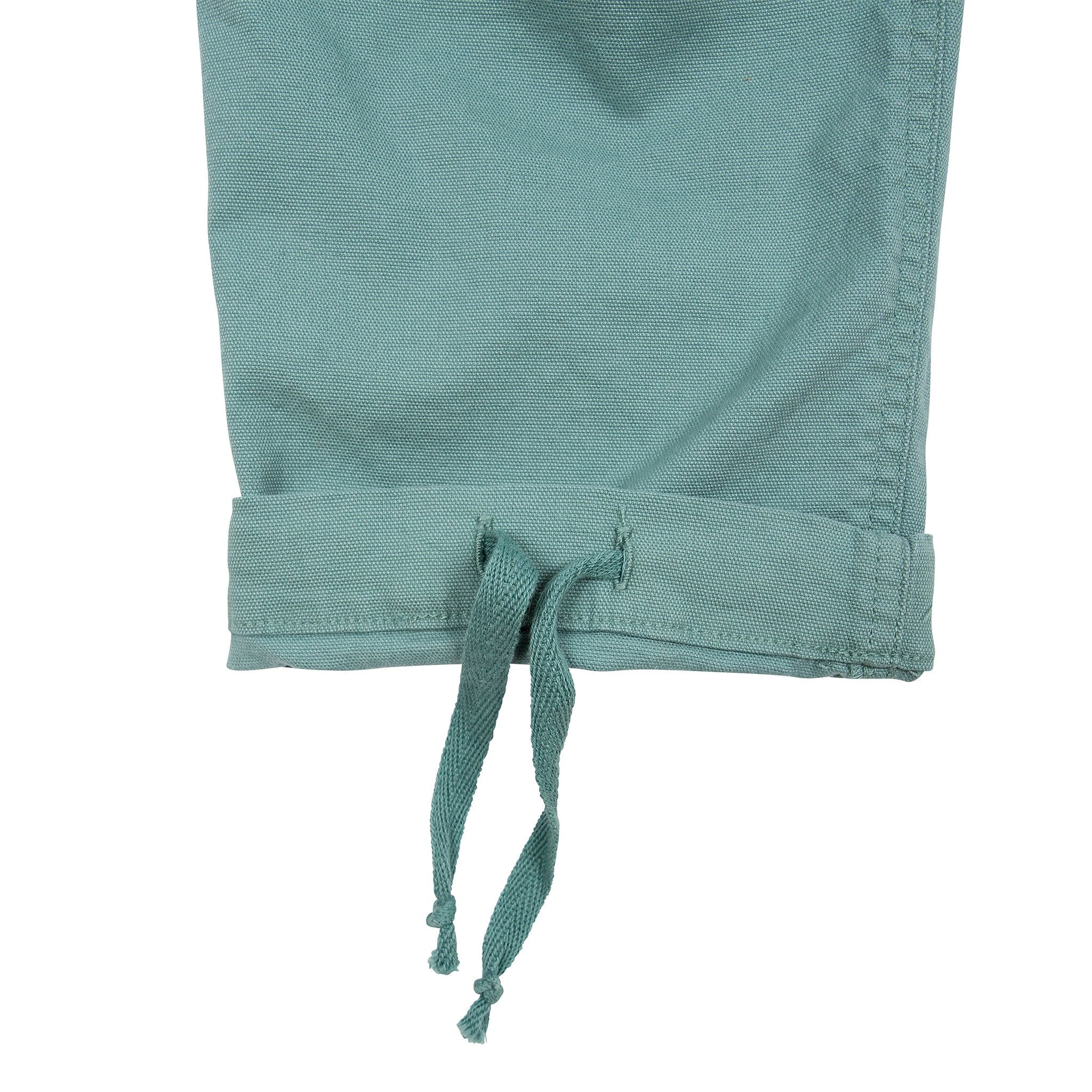 General detail shot of Topo Designs Women's Dirt Pants in Sage green showing drawstring on bottom hem on leg cuff.