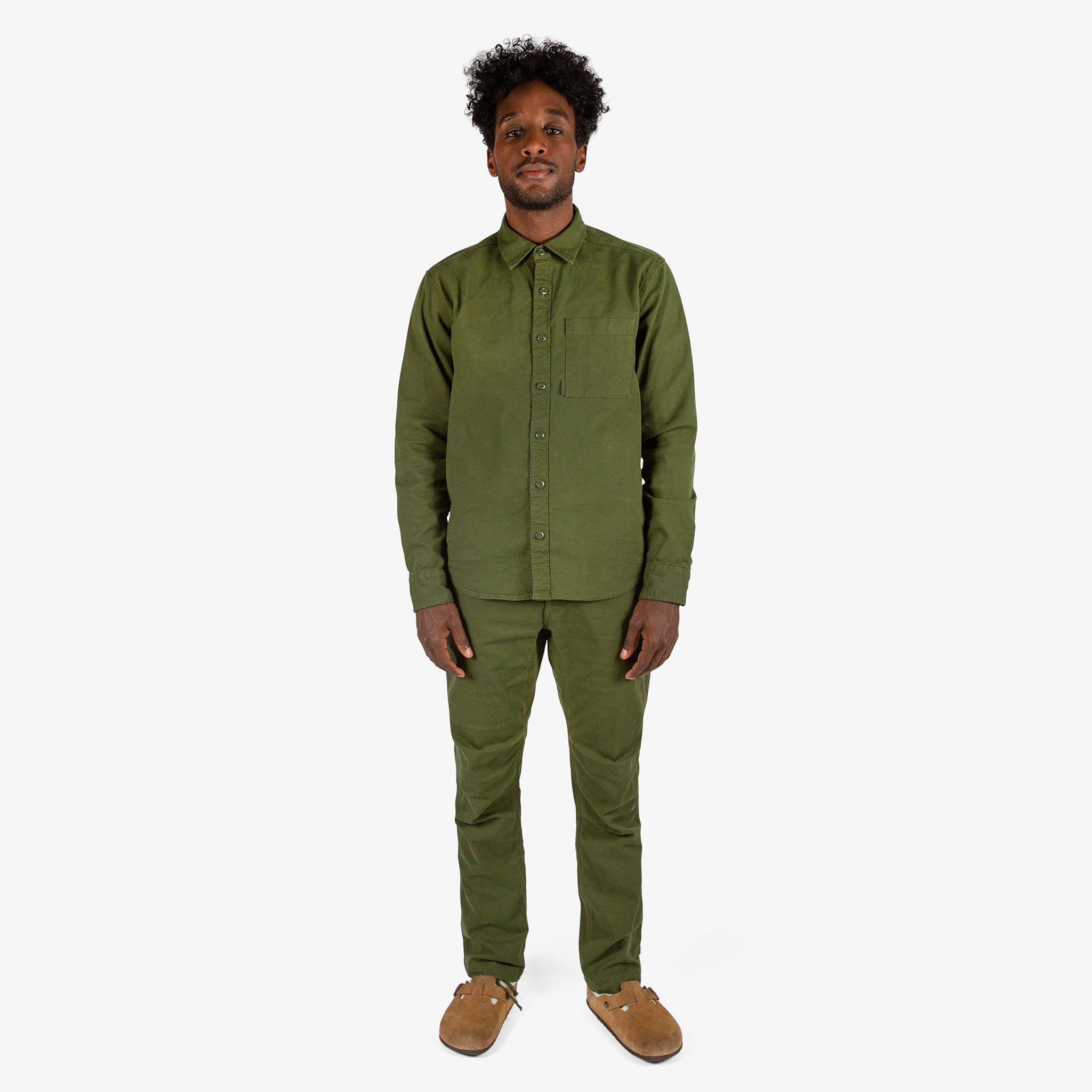 Full front model shot of Topo Designs Men's Dirt Shirt & Pants in "Olive" green.