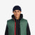 Front close up model shot of Topo Designs Men's Mountain Puffer recycled insulated Vest in "Forest" green.