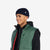 Three quarter close up model shot of Topo Designs Men's Mountain Puffer recycled insulated Vest in "Forest" green.