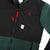 General detail product shot of the men's subalpine fleece in black/forest showing front chest pocket.