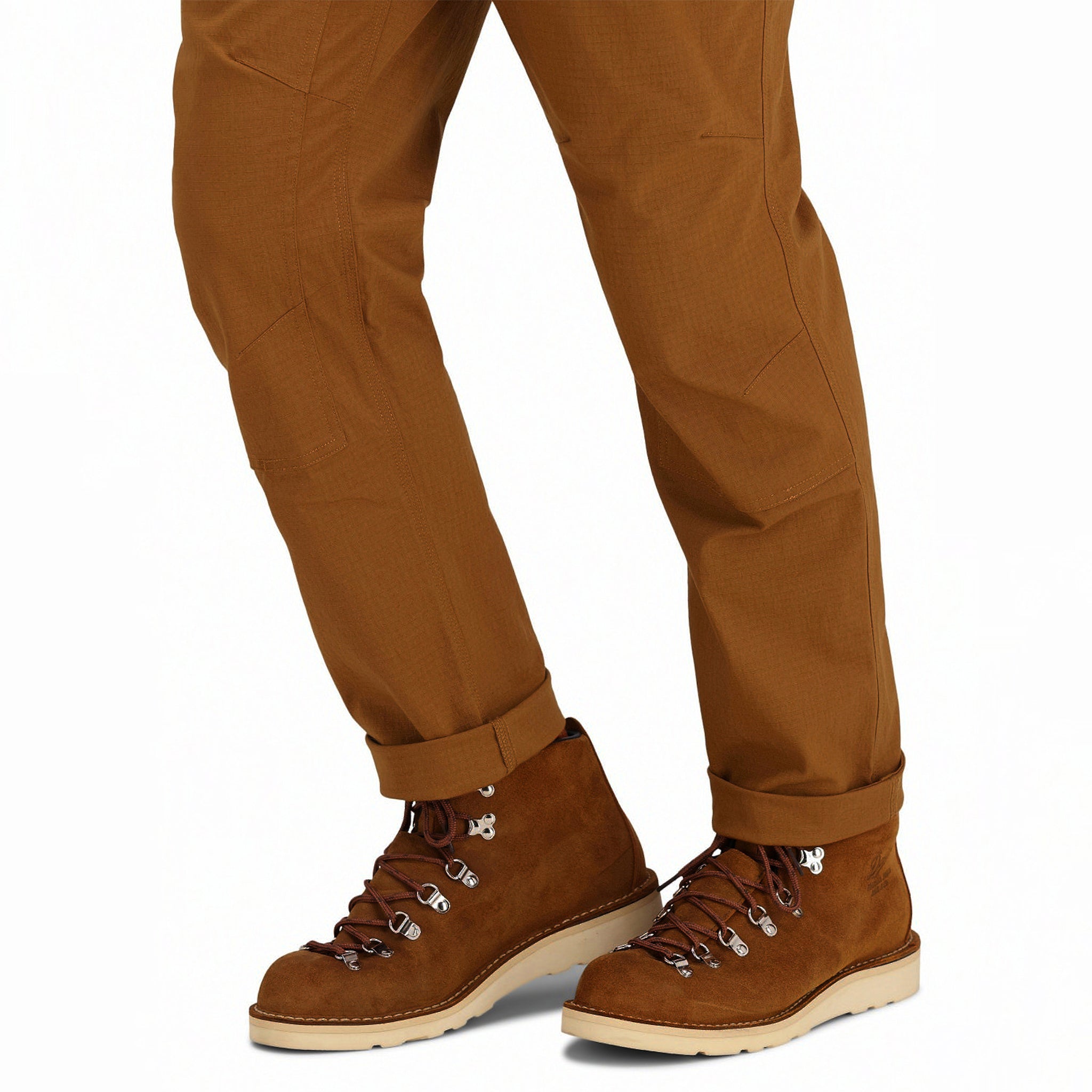 General front model shot of Topo Designs Men's Mountain lightweight hiking Pants Ripstop in "Earth" brown showing articulated knees, and cuffed ankles.
