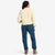 Back model shot of Topo Designs Women's Dirt Jacket 100% organic cotton shirt jacket in "sand" brown white. Show on "brick"