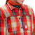 Detail model shot of Topo Designs Women's Mountain Shirt Jacket in "red / yellow plaid" showing chest pockets and buttons. Show on "brown / natural plaid"