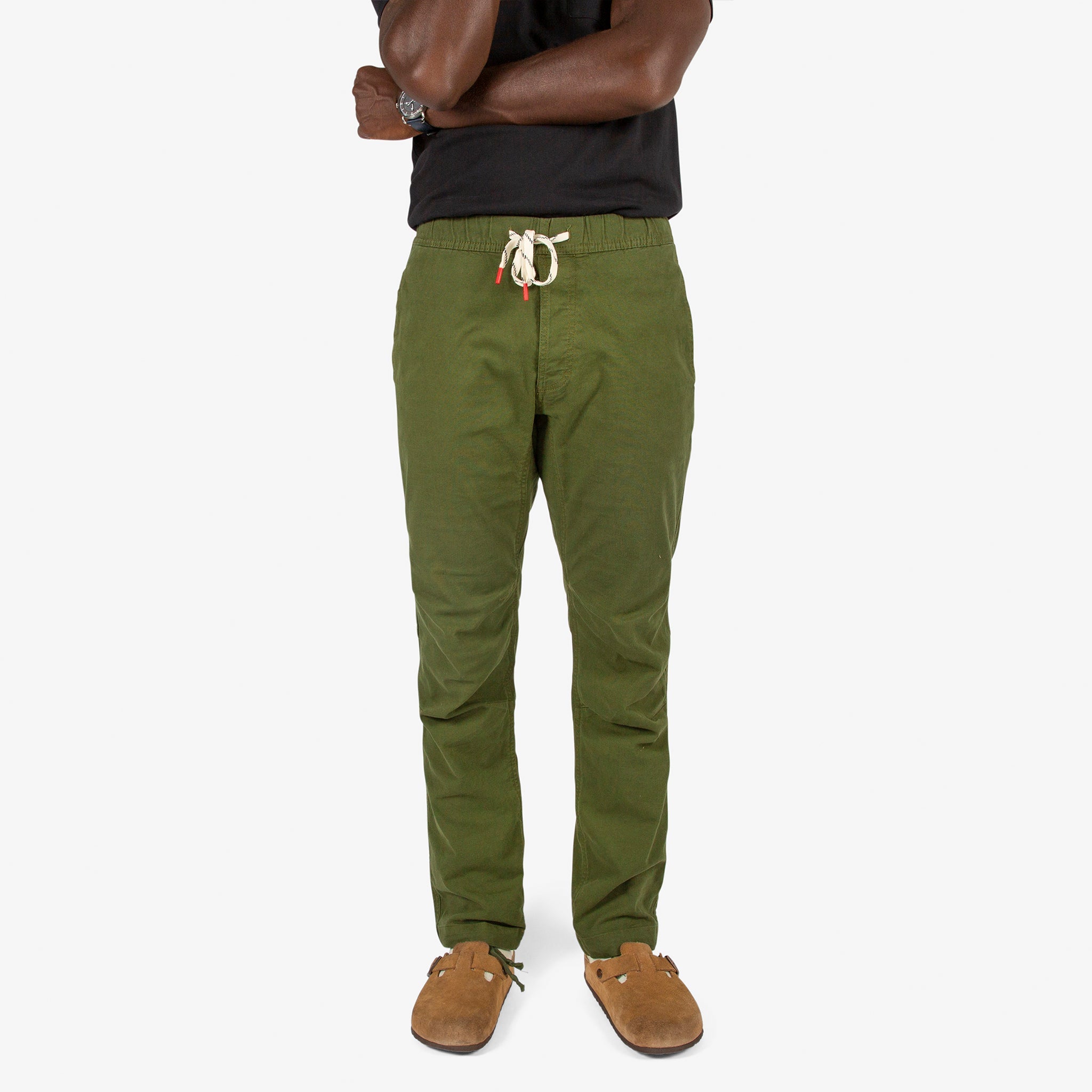 Close-up front model shot of Topo Designs Men's Dirt Shirt & Pants in "Olive" green.