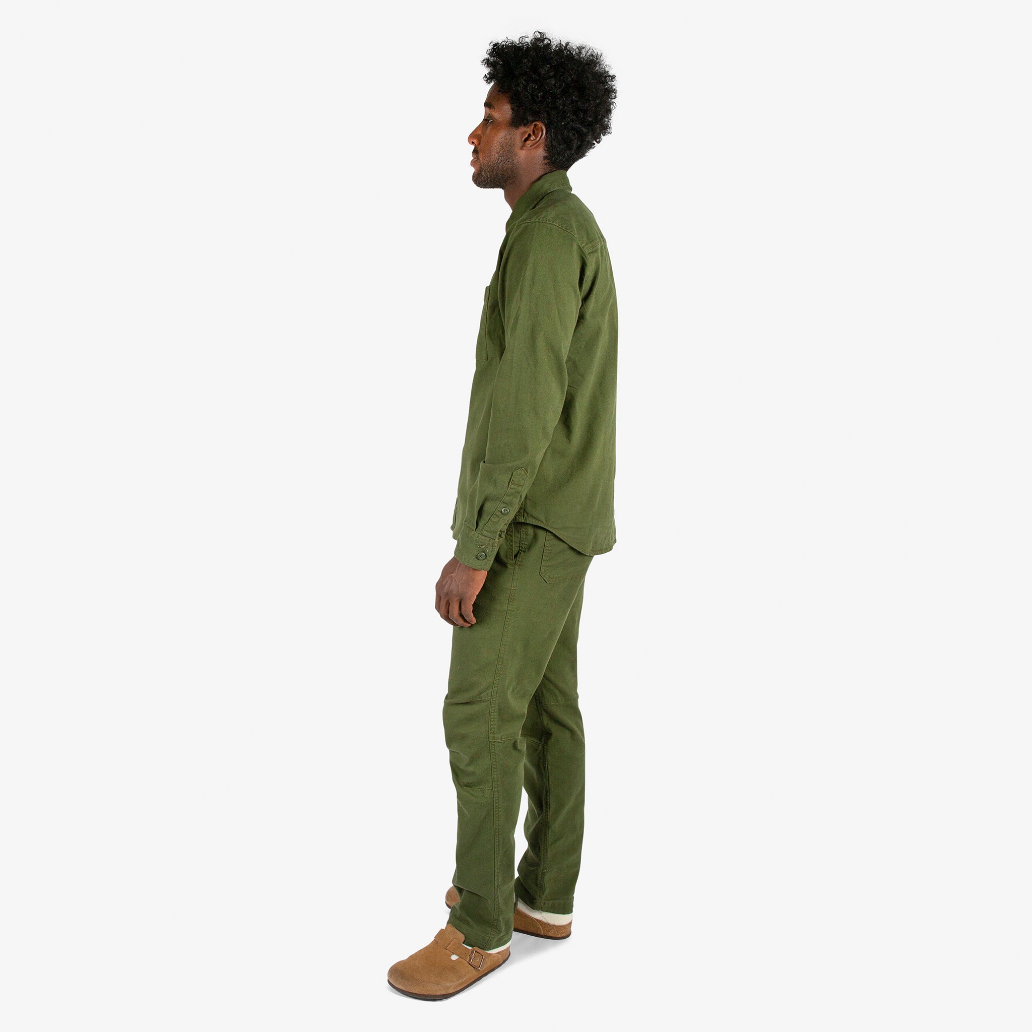 Full side model shot of Topo Designs Men's Dirt Shirt & Pants in "Olive" green.