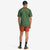 General back shot of model wearing Topo Designs Men's River Tee Short Sleeve UPF 30+ moisture wicking t-shirt in olive green terrazzo print.