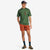 General shot of model wearing Topo Designs Men's River Tee Short Sleeve UPF 30+ moisture wicking t-shirt in olive green terrazzo print.