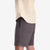 General on model front shot of Topo Designs Men's drawstring Dirt Shorts 100% organic cotton in "Charcoal" gray.
