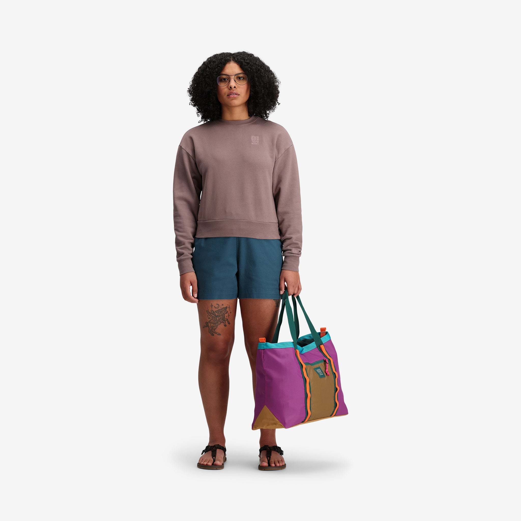 Model shot of Topo Designs Women's Dirt Crew sweatshirt in 100% organic cotton French terry in "Peppercorn" purple brown. Show on "sage".