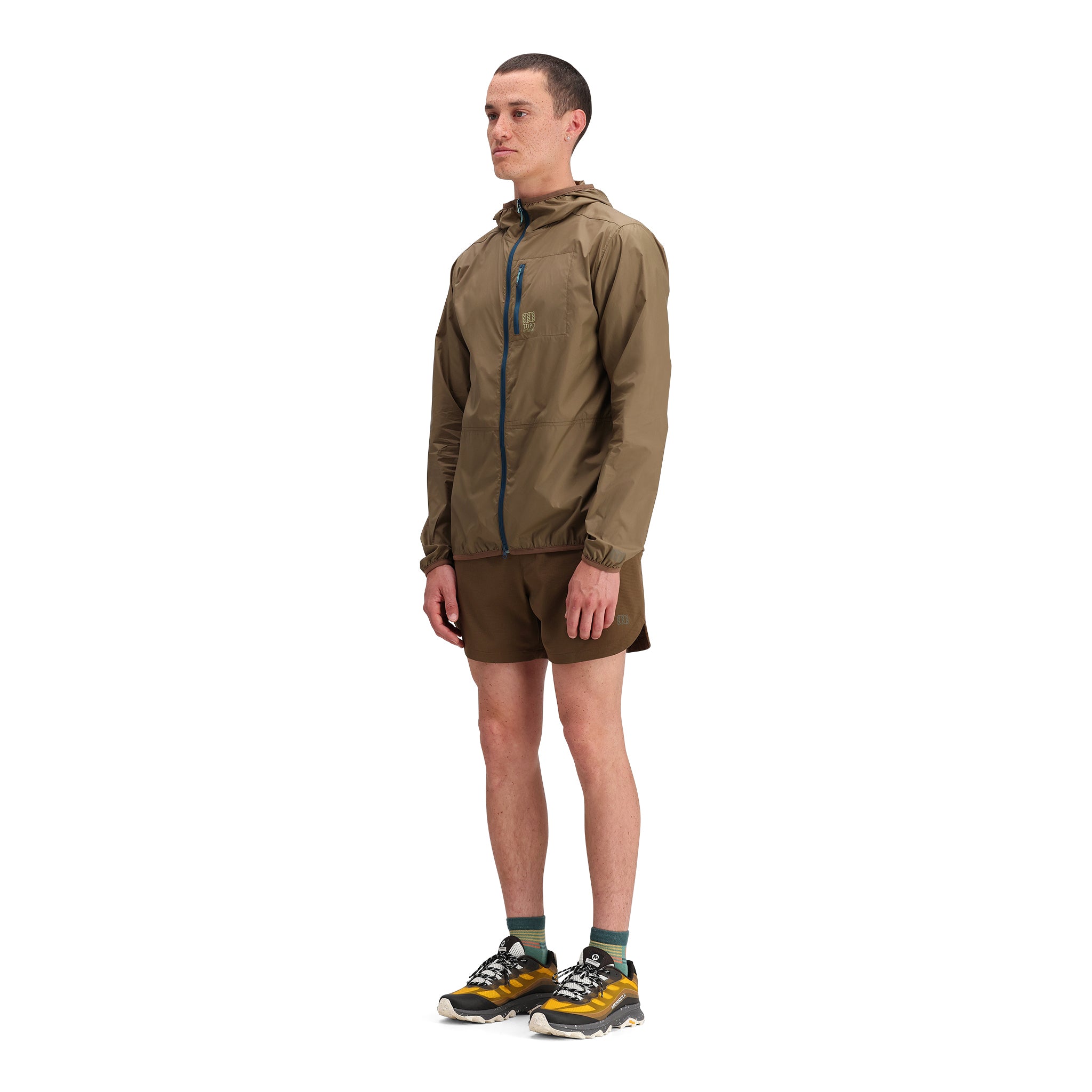 General side model shot of Topo Designs Global Trek Shorts 7" - Men's in "Desert Palm"