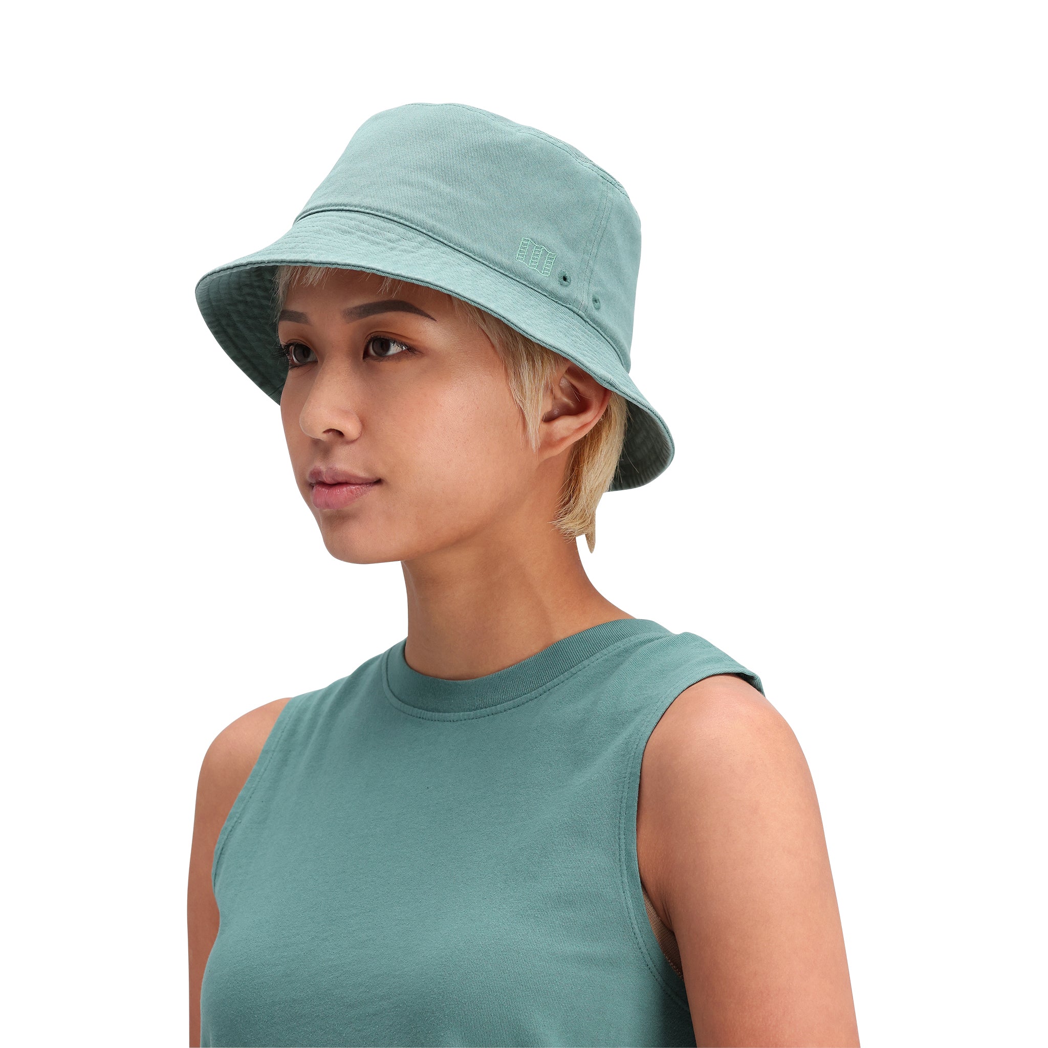 General side model shot of Topo Designs Dirt Bucket Hat in "Sea Pine"