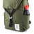 General front detail shot of Topo Designs Y-Pack in olive green showing water bottle pocket