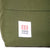 Front logo patch on Topo Designs Daypack Classic 100% recycled nylon laptop backpack for work or school in Olive green.