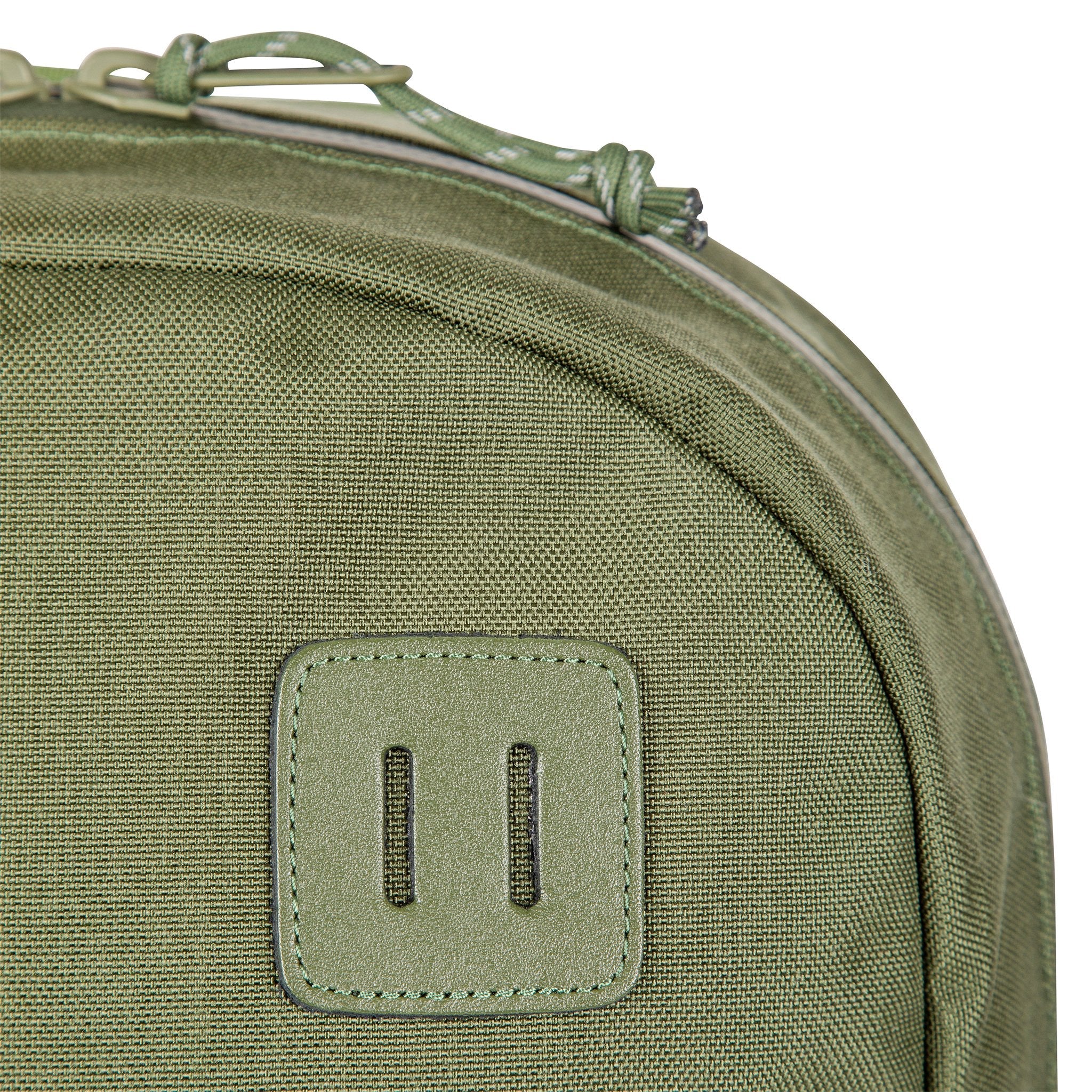 General shot of lash tab on Topo Designs Daypack Tech 100% recycled nylon backpack in "Olive" green.