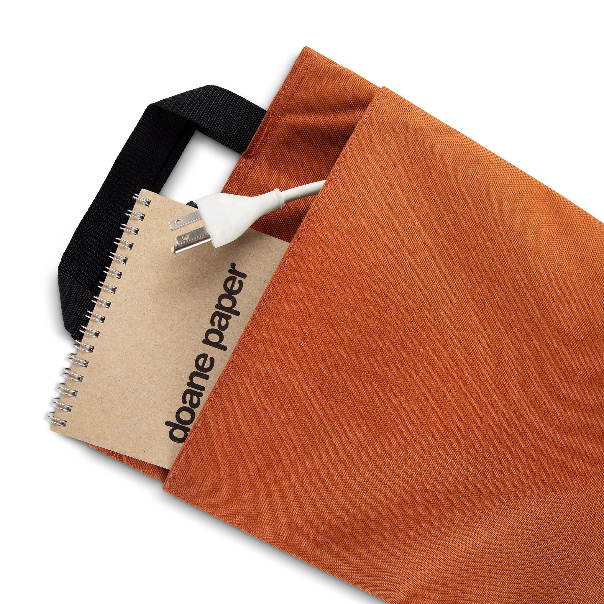 General back pocket detail shot of Topo Designs padded Laptop Sleeve in Clay orange.