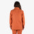 Back model shot of Topo Designs Women's Dirt Shirt & Pants in "Brick" orange. Show on "Peppercorn" & "Black"
