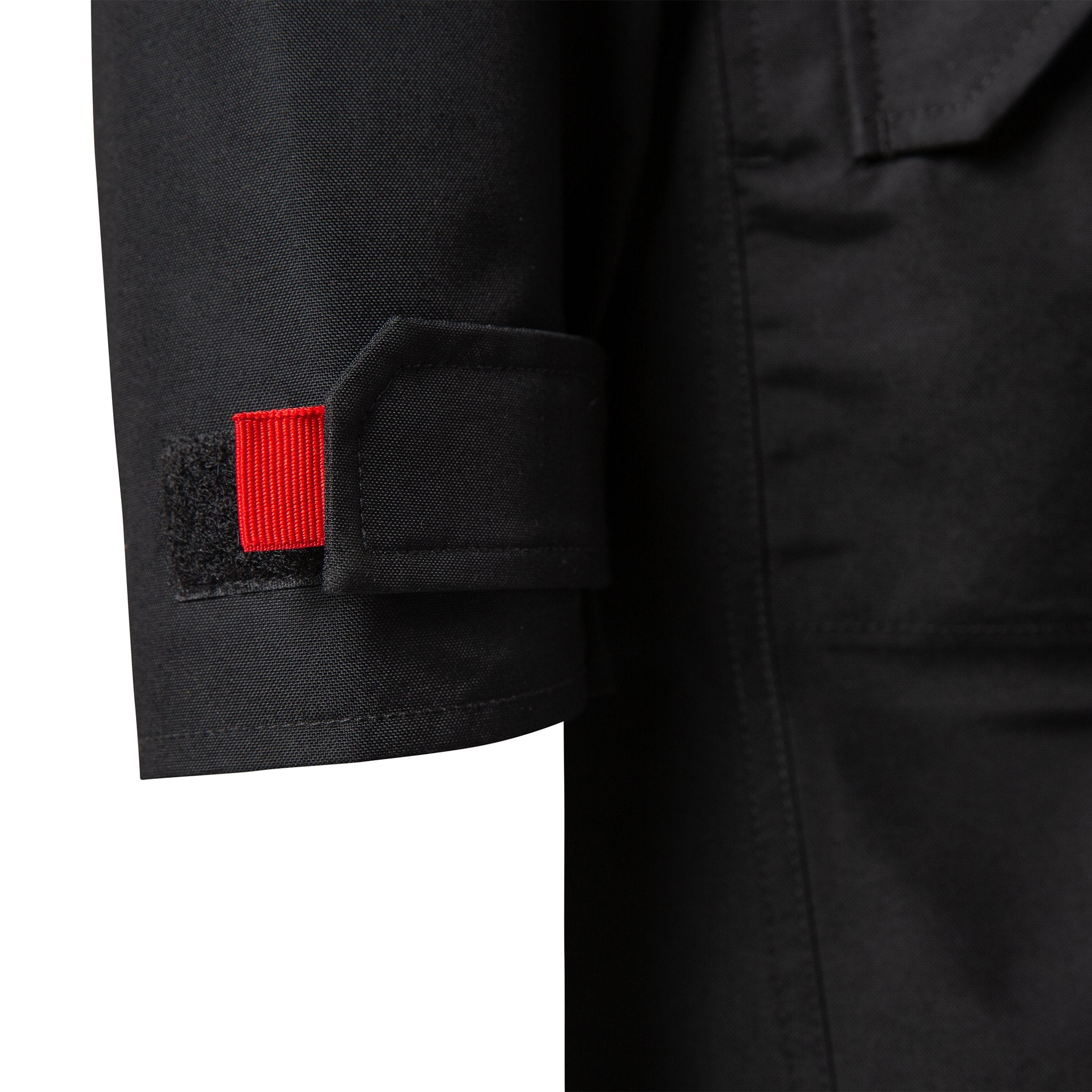 Detail product shot of women's tech trench 3L in black showing hook and loop cuff adjustment with webbing pull tabs