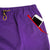 Detail shot of Topo Designs Women's Sport Skirt in Purple showing phone in front zipper pockets.