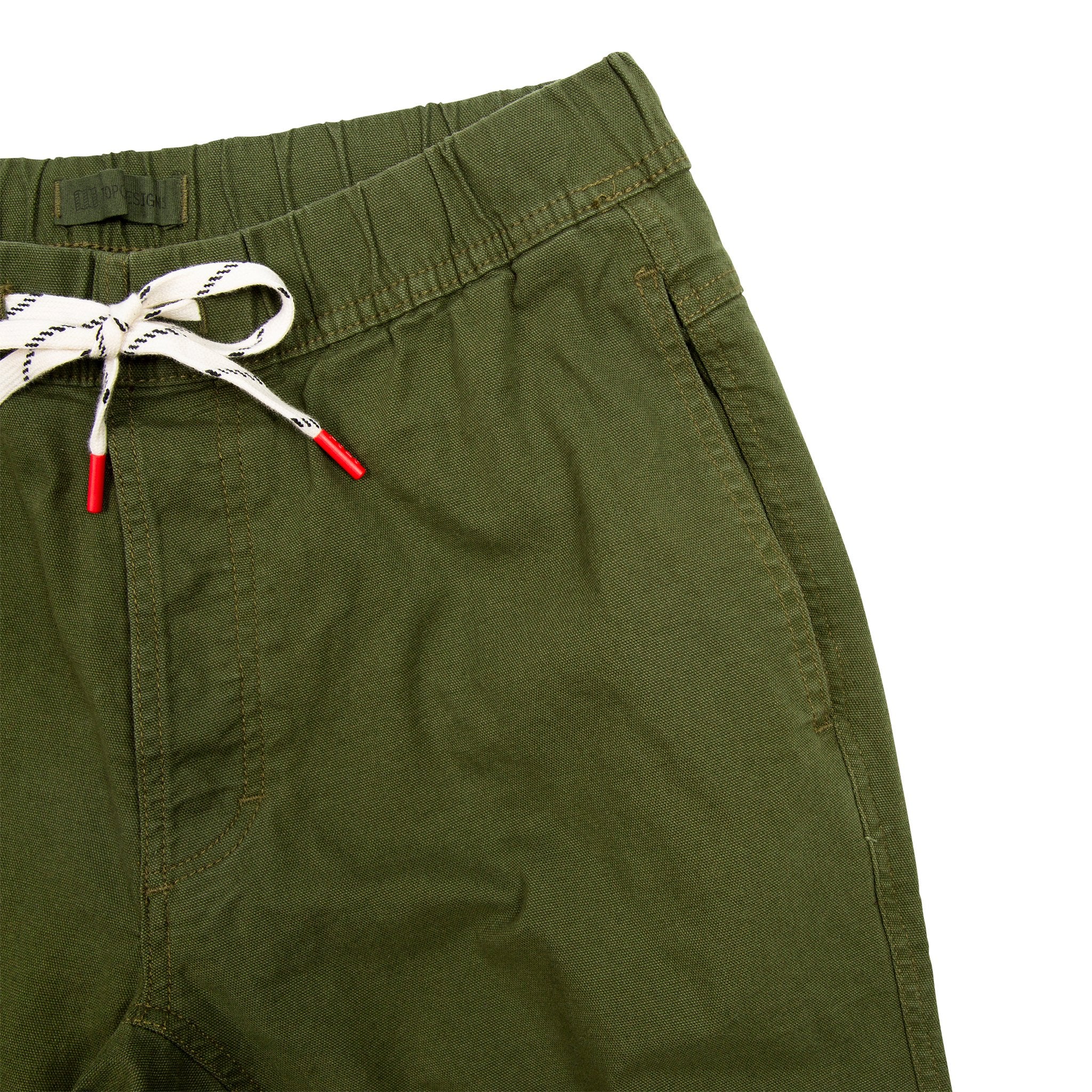General detail shot of Topo Designs Men's Dirt Pants in Olive green showing drawstring waistband and hand pocket.