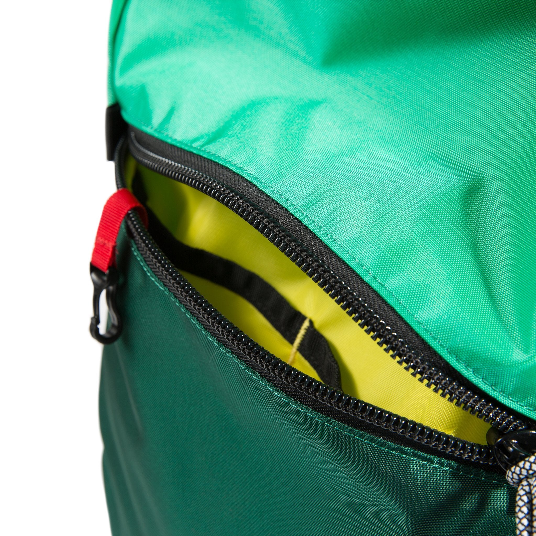 General detail product shot of Light Pack in Mint/Forest/Coral showing external zipper pocket and red key clip.