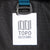 General shot of Topo Designs logo patch on Global Travel Bag Roller durable carry-on convertible laptop backpack rolling suitcase in Navy blue.