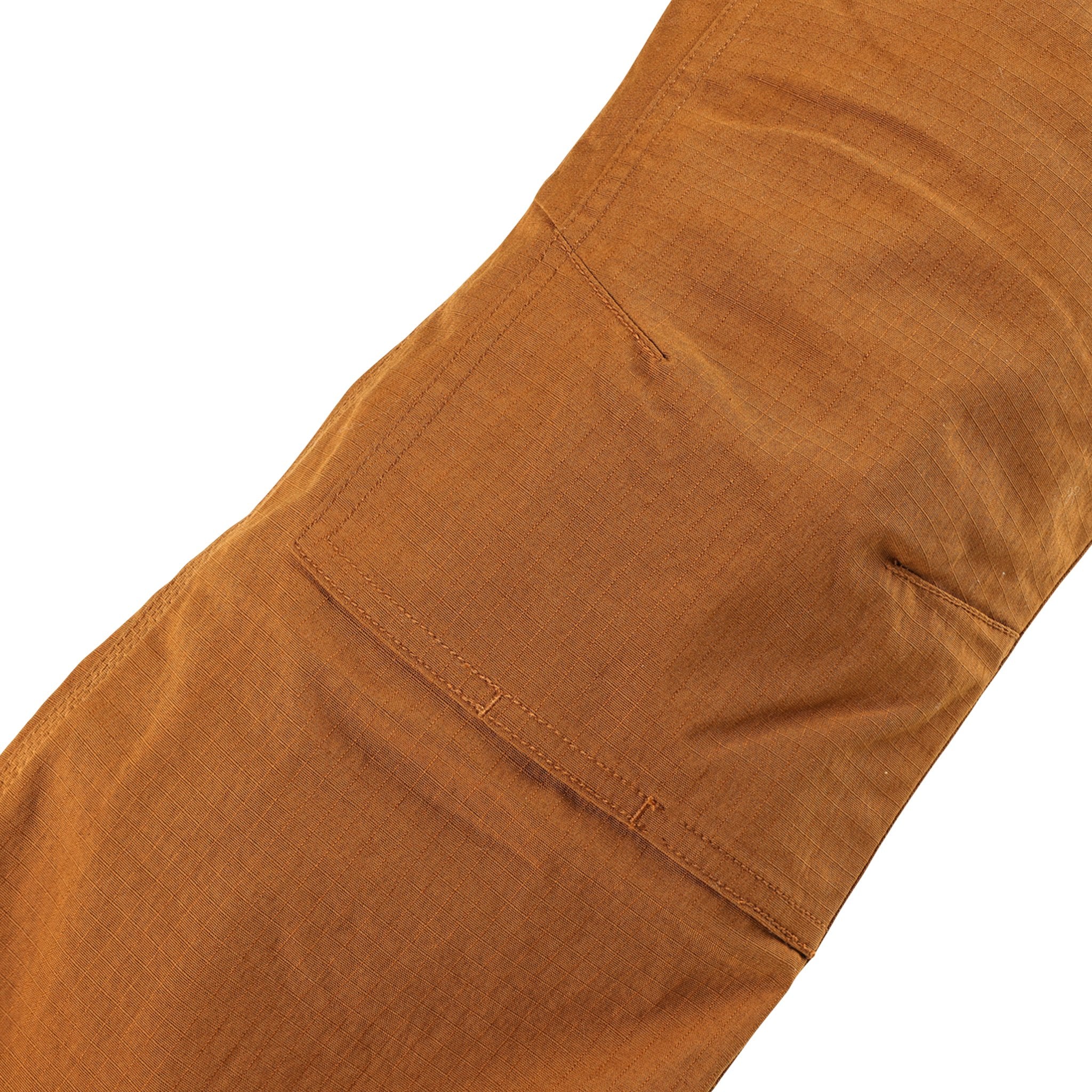 General shot of reinforced knees on Topo Designs Men's Mountain lightweight hiking Pants Ripstop in Earth brown.