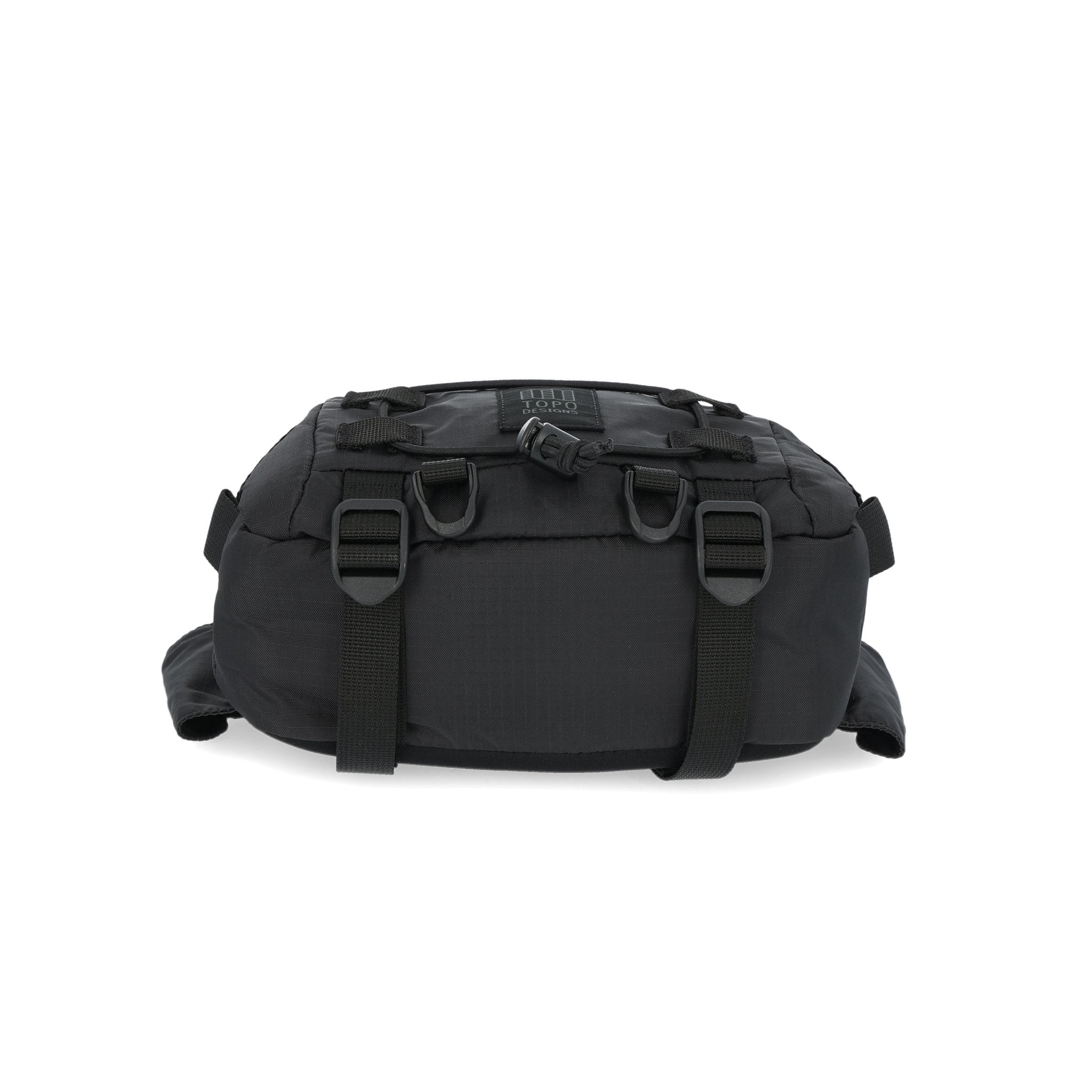 Bottom compression straps on Topo Designs Mountain Hip Pack lumbar bum bag in Black.