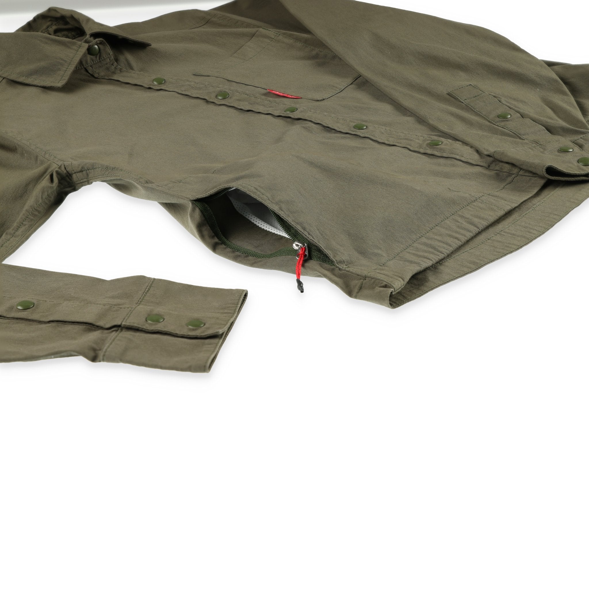 General shot of Topo Designs Women's Global long sleeve lightweight snap travel shirt in olive green showing side zipper hand pocket.