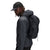 Model wearing Topo Designs TopoLite Cinch Pack 16L packable daypack backpack for travel in "black"