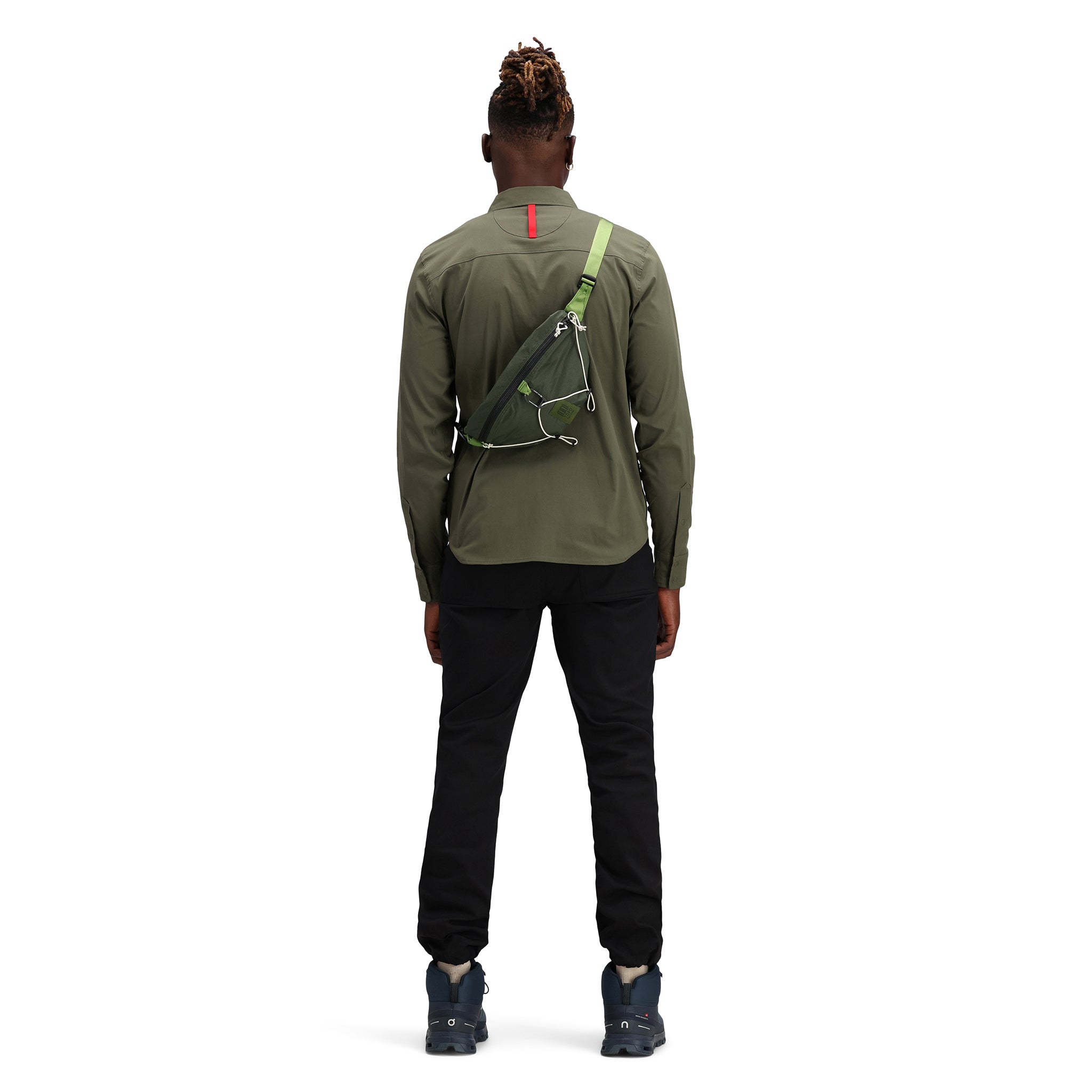 Back of model wearing Topo Designs Men's Global Shirt long sleeve lightweight travel snap shirt in "olive" green. Show on "Pond Blue".