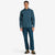 Model wearing Topo Designs Men's Global Shirt long sleeve lightweight travel snap shirt in "Pond Blue".