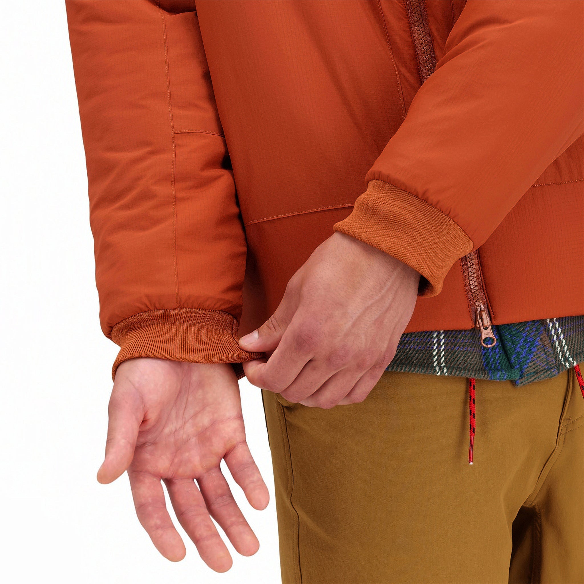 General detail shot of cuffs on Topo Designs Mountain Puffer Primaloft insulated Hoodie jacket in "Brick" orange