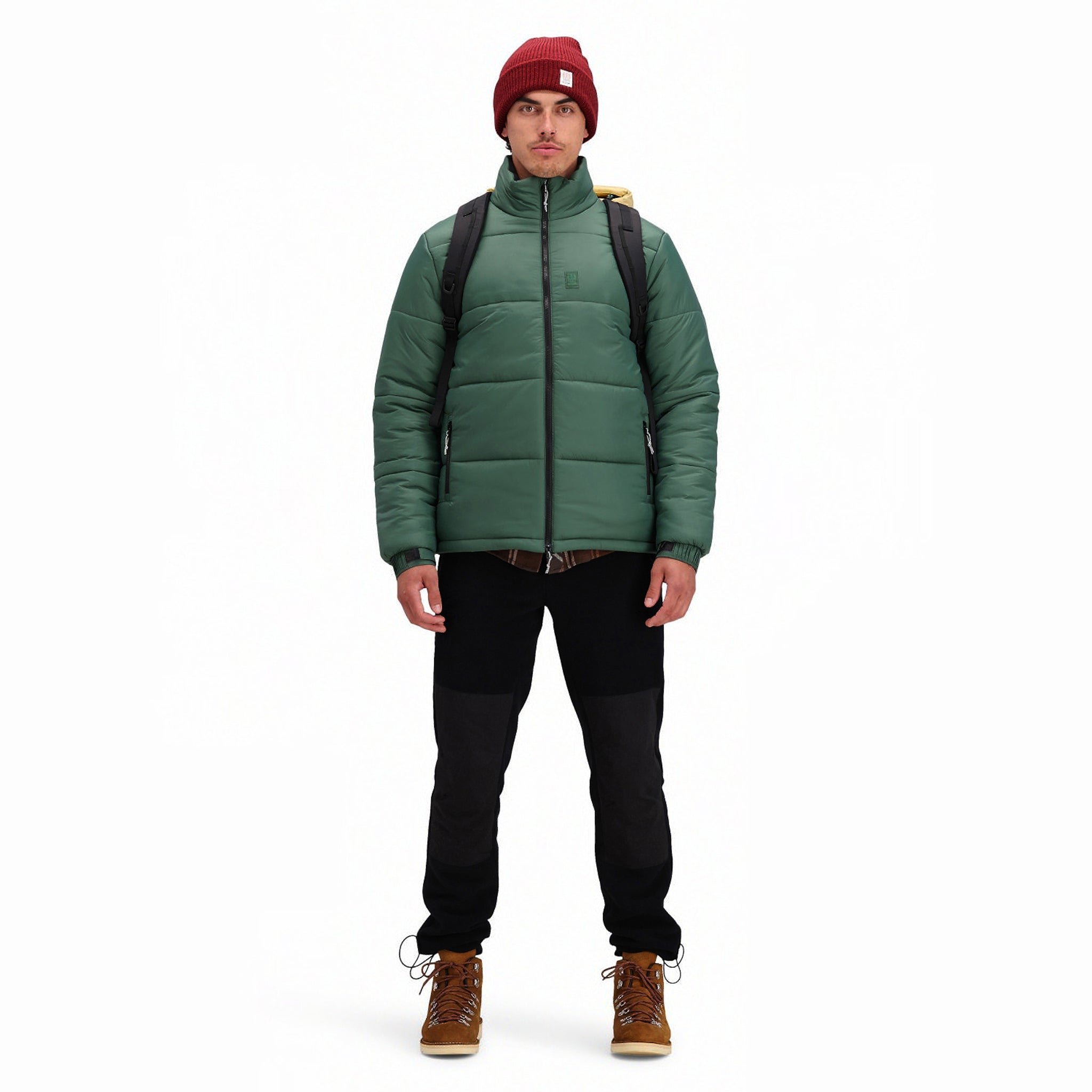 Front model shot of Topo Designs Men's Puffer recycled insulated Jacket in "Forest" green.