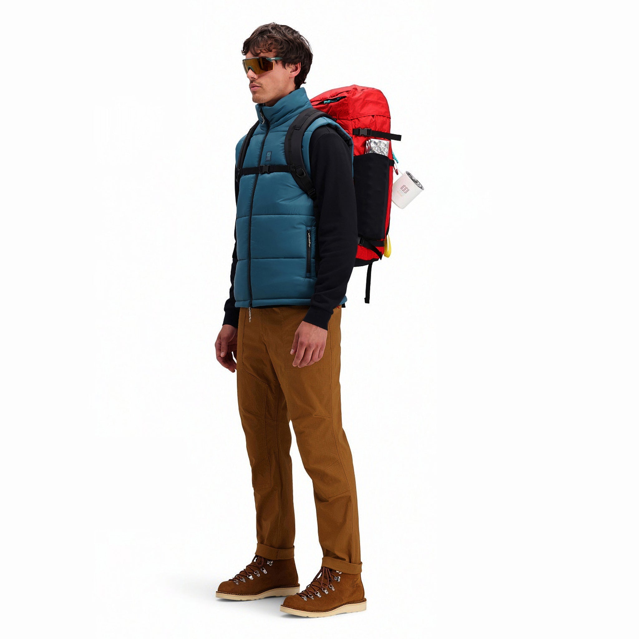 Side model shot of Topo Designs Men's Mountain Puffer recycled insulated Vest in "Pond Blue"