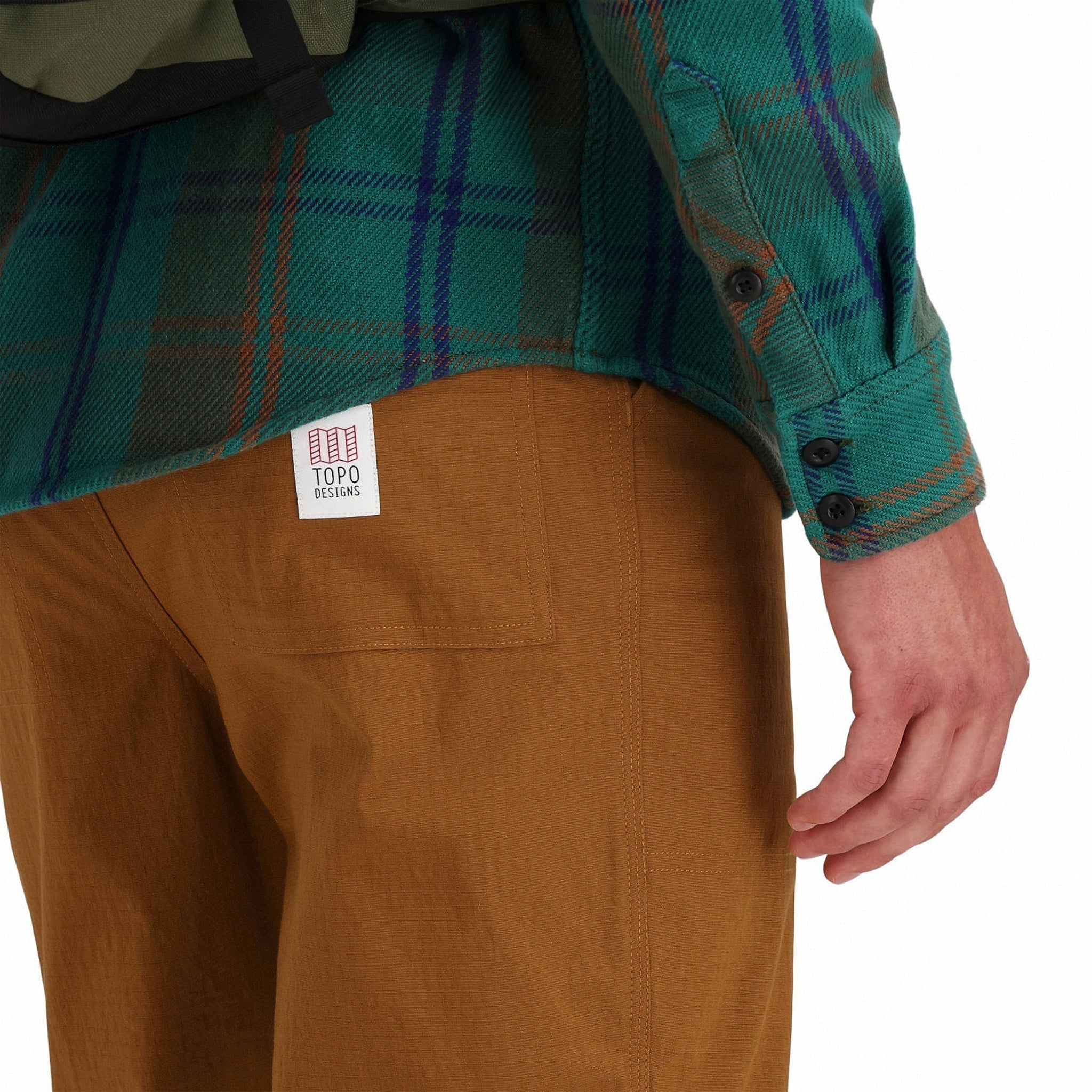 Back detail shot of sleeve cuff buttons on Topo Designs Men's Mountain Shirt Heavyweight "Green / Earth Plaid" brown blue button-up.
