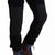 General front model detail shot of reinforced knee panels on Topo Designs men's fleece pants in "black"