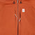General detail shot of chest zipper pockets on Topo Designs Mountain Puffer Primaloft insulated Hoodie jacket in "Brick" orange