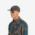 Side model shot of Topo Designs Nylon Ball Cap Split Topo embroidered logo hat in "forest" green