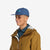 Side model shot of Topo Designs Nylon Ball Cap Split Topo embroidered logo hat in "pond blue"