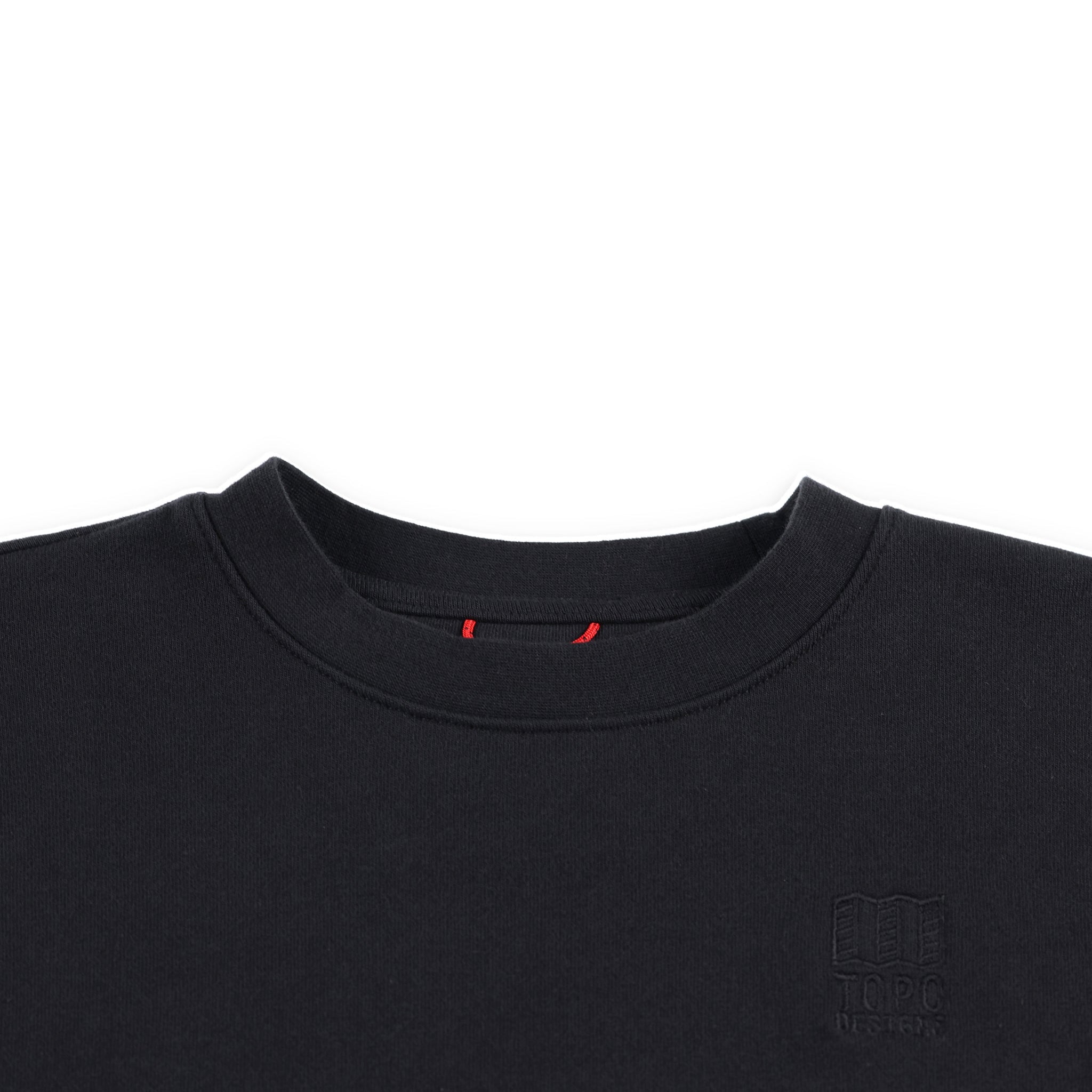 General detail shot of neckline and embroidered chest logo on Topo Designs Women's Dirt Crew sweatshirt in 100% organic cotton French terry in "black"