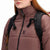 Front model shot of Topo Designs Women's Puffer recycled insulated Jacket in "Peppercorn" purple brown showing zipper and chest logo.
