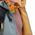 Model shot of Topo Designs Women's Puffer Primaloft insulated Hoodie jacket in "slate" blue showing interior lining.