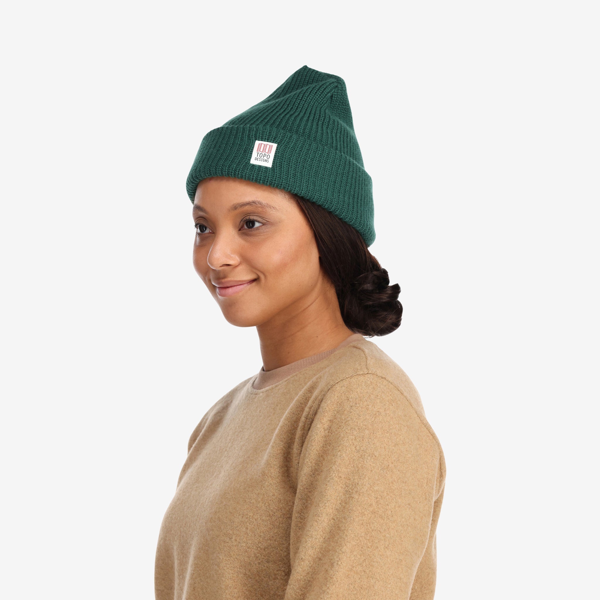 Side model shot of Topo Designs Watch Cap cuffed beanie in "forest" green.