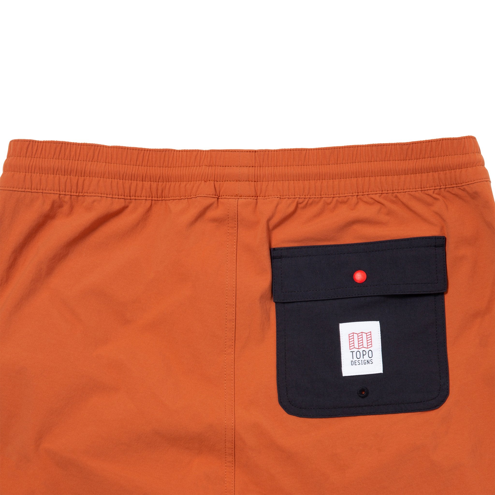 Back detail shot of Topo Designs Men's Global Shorts in Clay showing rear snap pocket with drain grommet