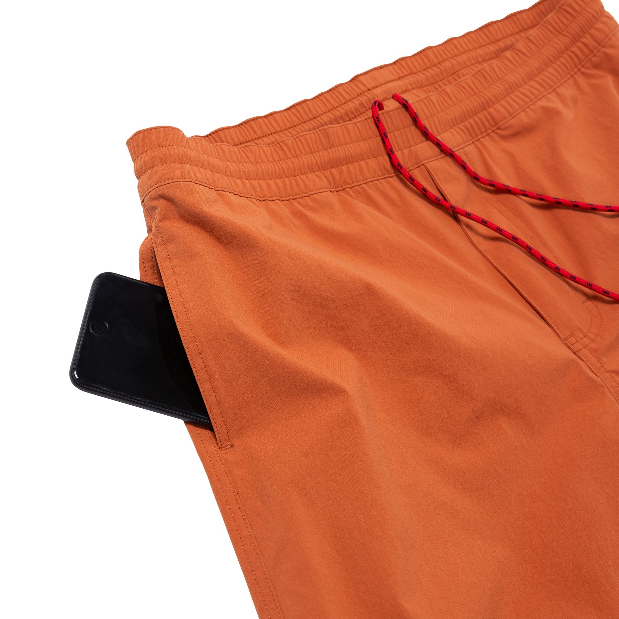Detail shot of Topo Designs Men's Global Shorts in Clay showing mesh-lined side seam pocket