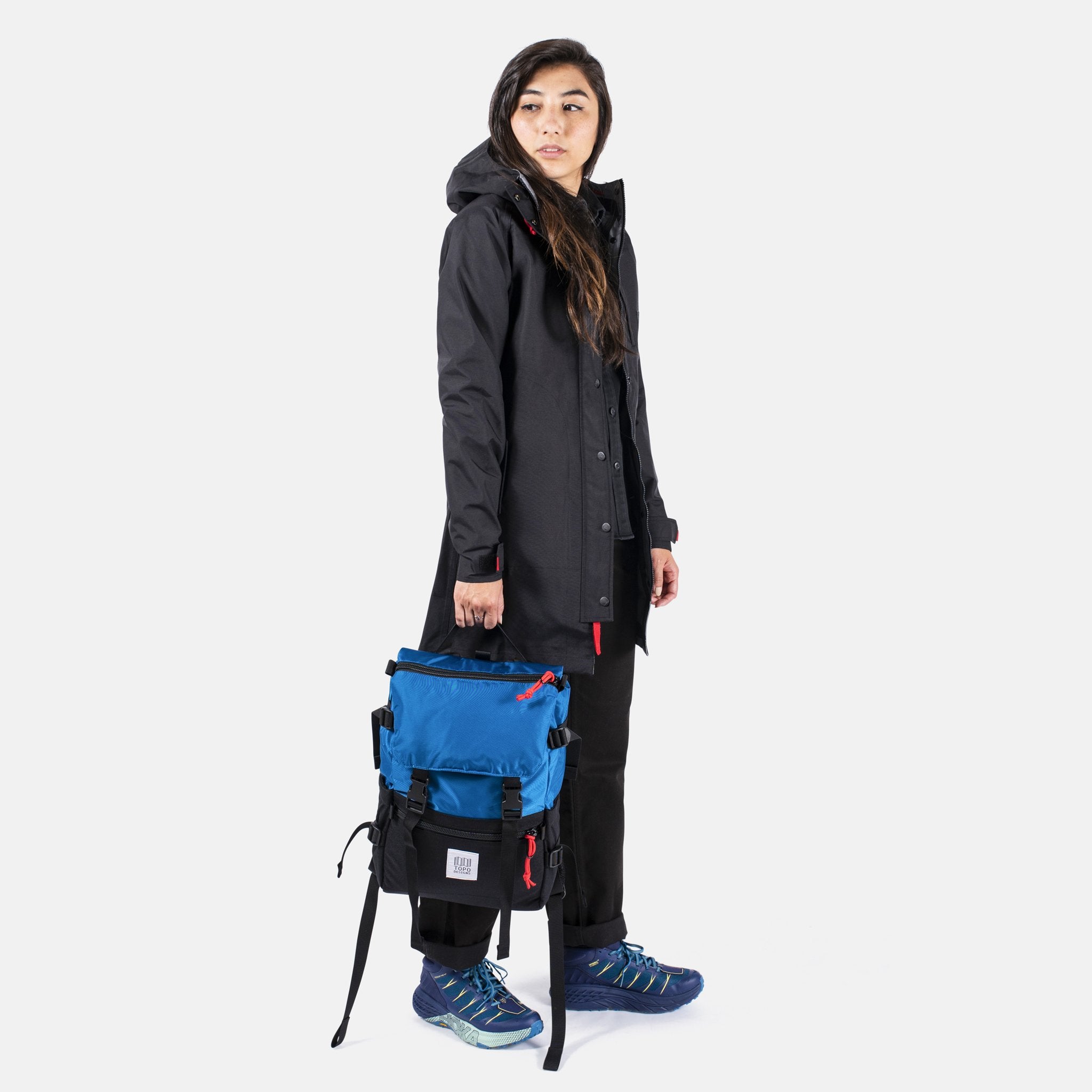 Side Model Shot of the Topo Designs Rover Pack Classic in Blue/Black