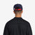 General shot of adjustable back strap on back of model's head of Topo Designs Corduroy Trucker Hat with Peaks & Valleys graphic patch on navy blue.