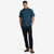 Model shot of Topo Designs Men's Short Sleeve 100% organic cotton button up Dirt Shirt in "Pond Blue" on model.