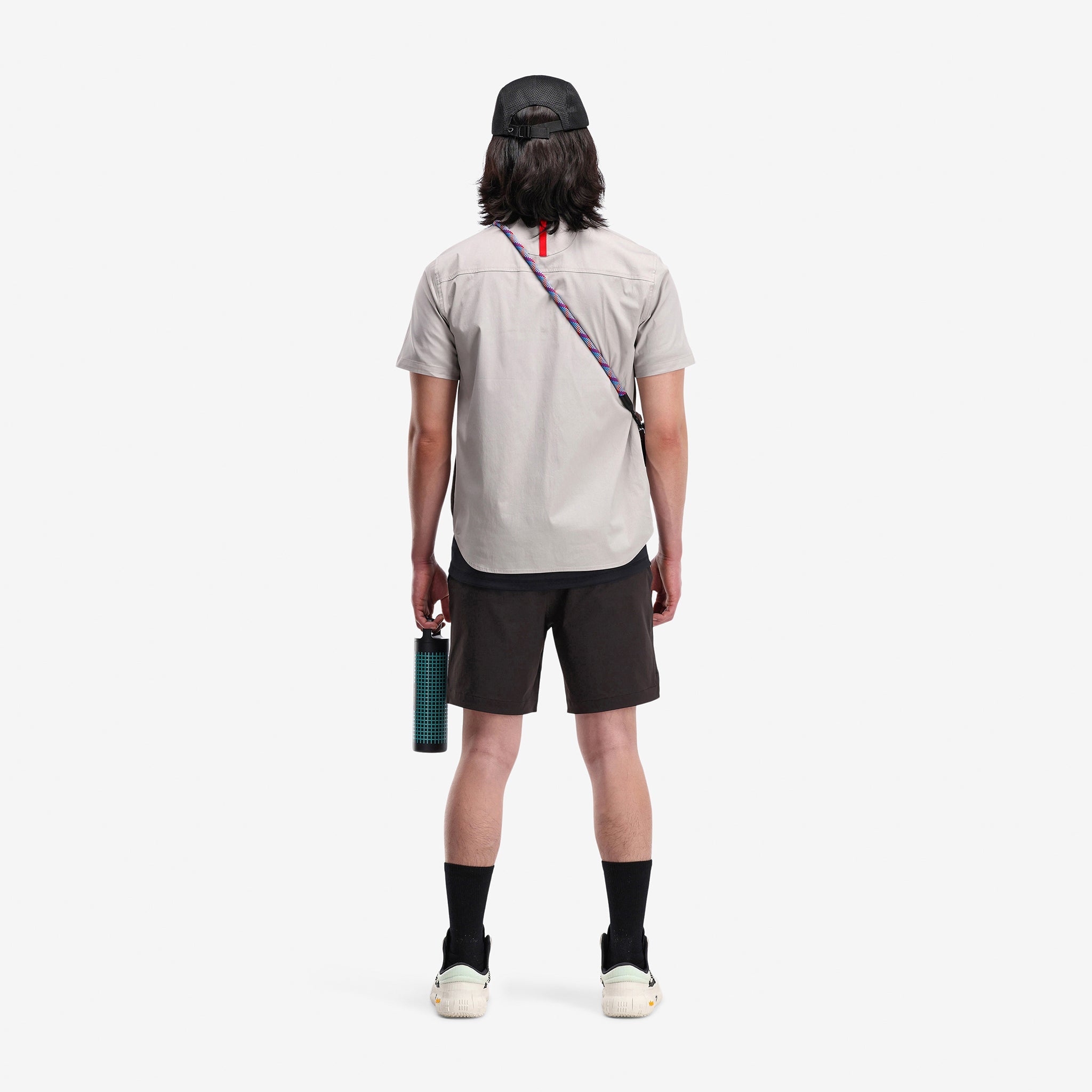 Back model shot of Topo Designs Men's Global lightweight quick dry travel Shorts in "black"